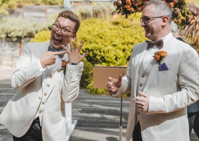 Groom & Groom -groom pointing to ring - we're married!!